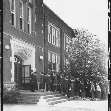 graduates walking into Schofiled for Commencement 