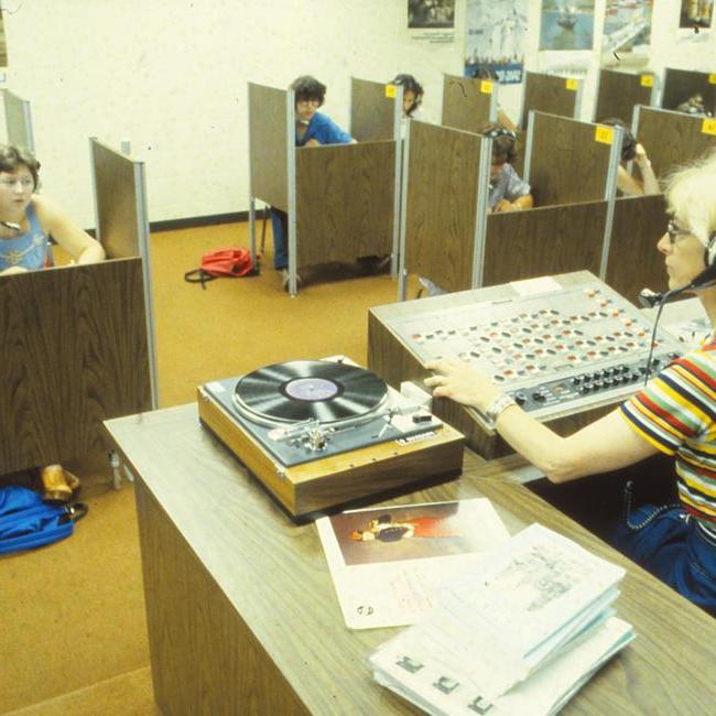 An instructor playing exam materials for students, 1979